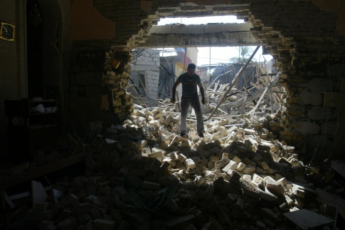 An Iraqi man inspects damages at the Mar